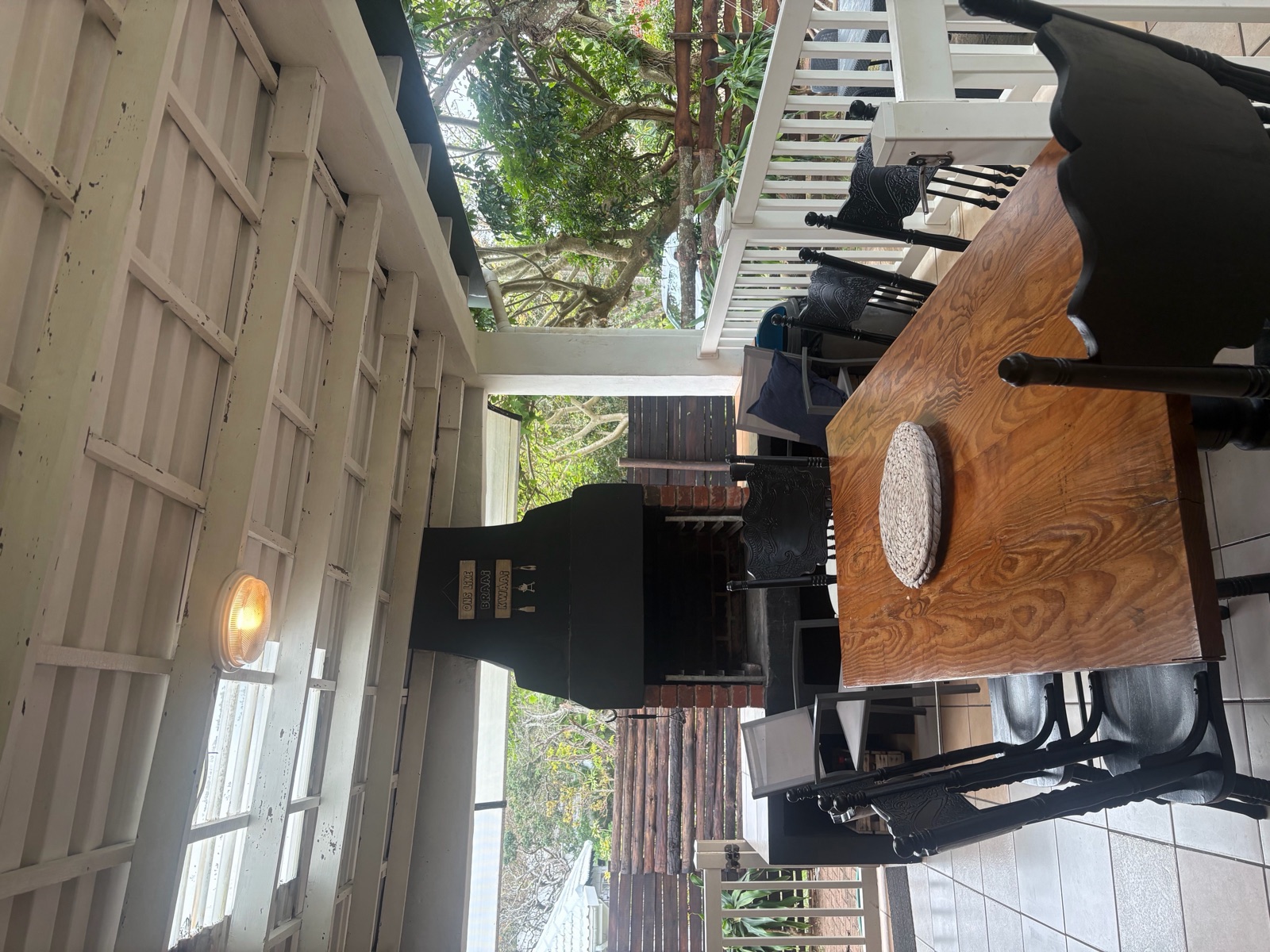 Outdoor dining table and built-in braai on the stoep